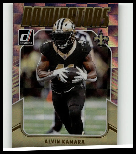 A gold and black 2024 donruss #25 alvin kamara dominators football trading card featuring kamara in a saints uniform