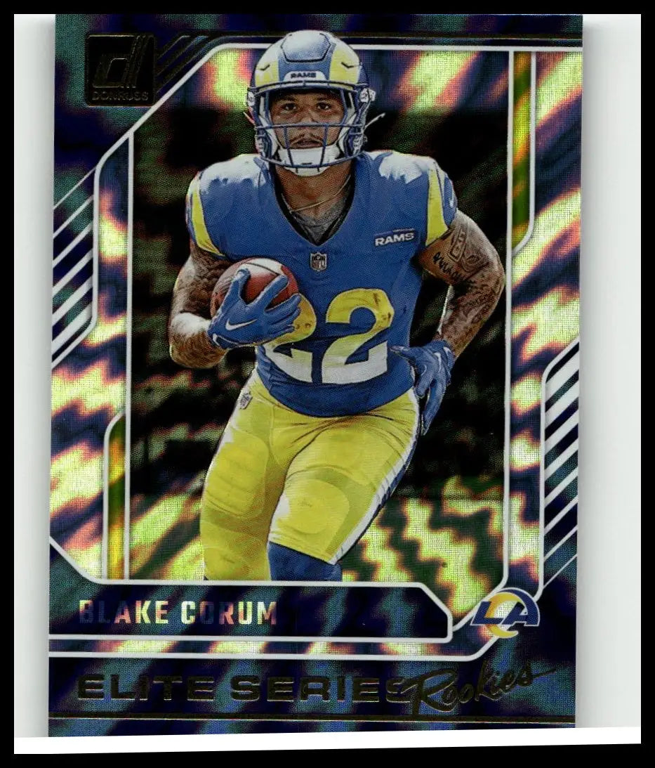 Blue and yellow los angeles rams blake corum in blue jersey number 22 holding ball 2024 donruss corum elite series card