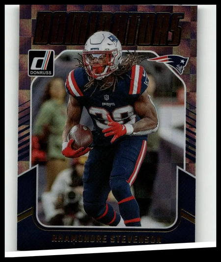 Image of 2024 Donruss rhamondre stevenson dominators football card featuring Stevenson in navy blue and red uniform holding ball