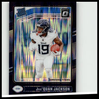 A vibrant blue and silver holographic donruss optic football card featuring jha’quan jackson in tennessee titans uniform
