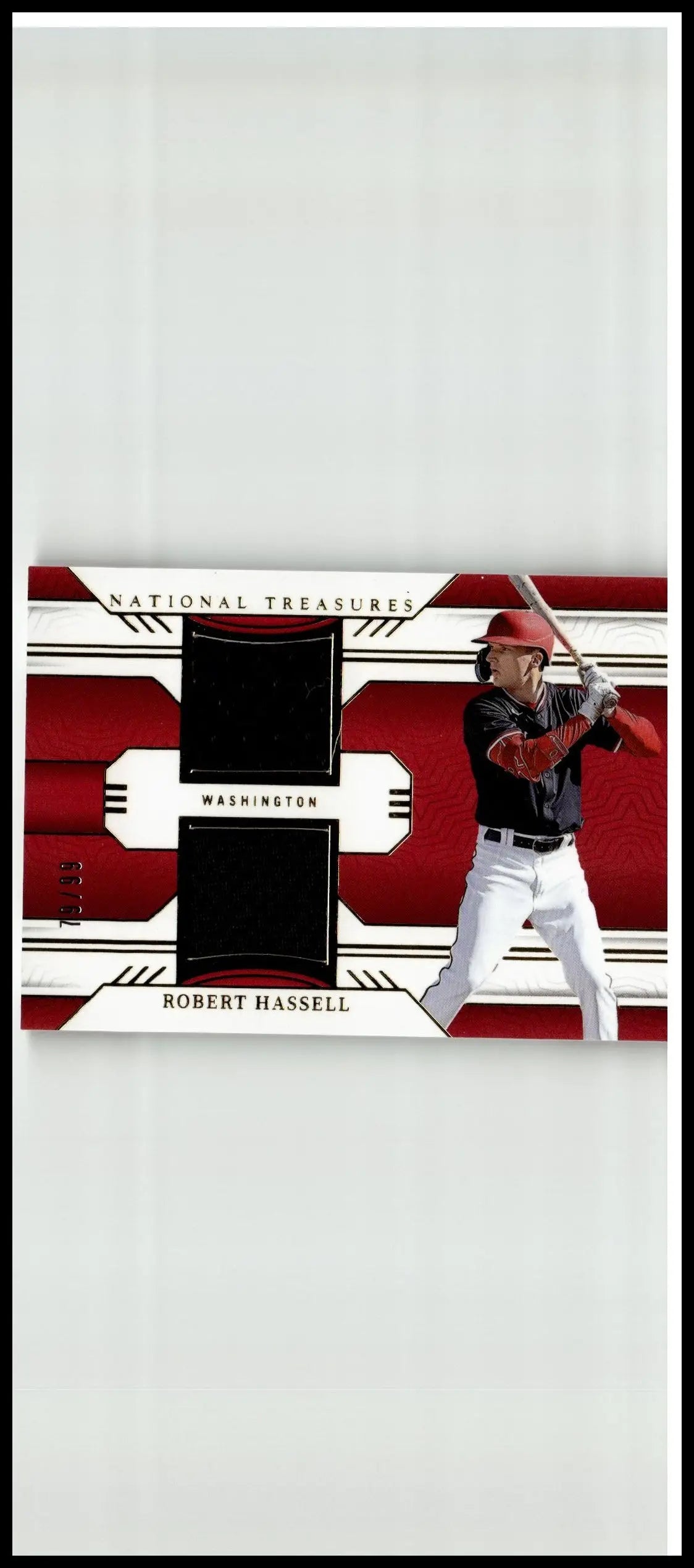 Red and white robert hassell panini national treasures baseball card featuring black fabric patches in batting stance