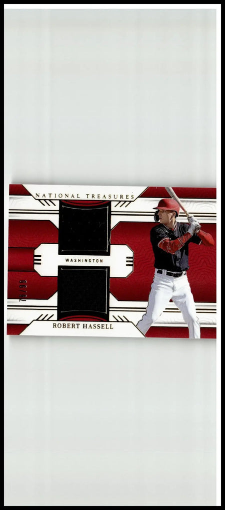 Red and white robert hassell panini national treasures baseball card featuring black fabric patches in batting stance