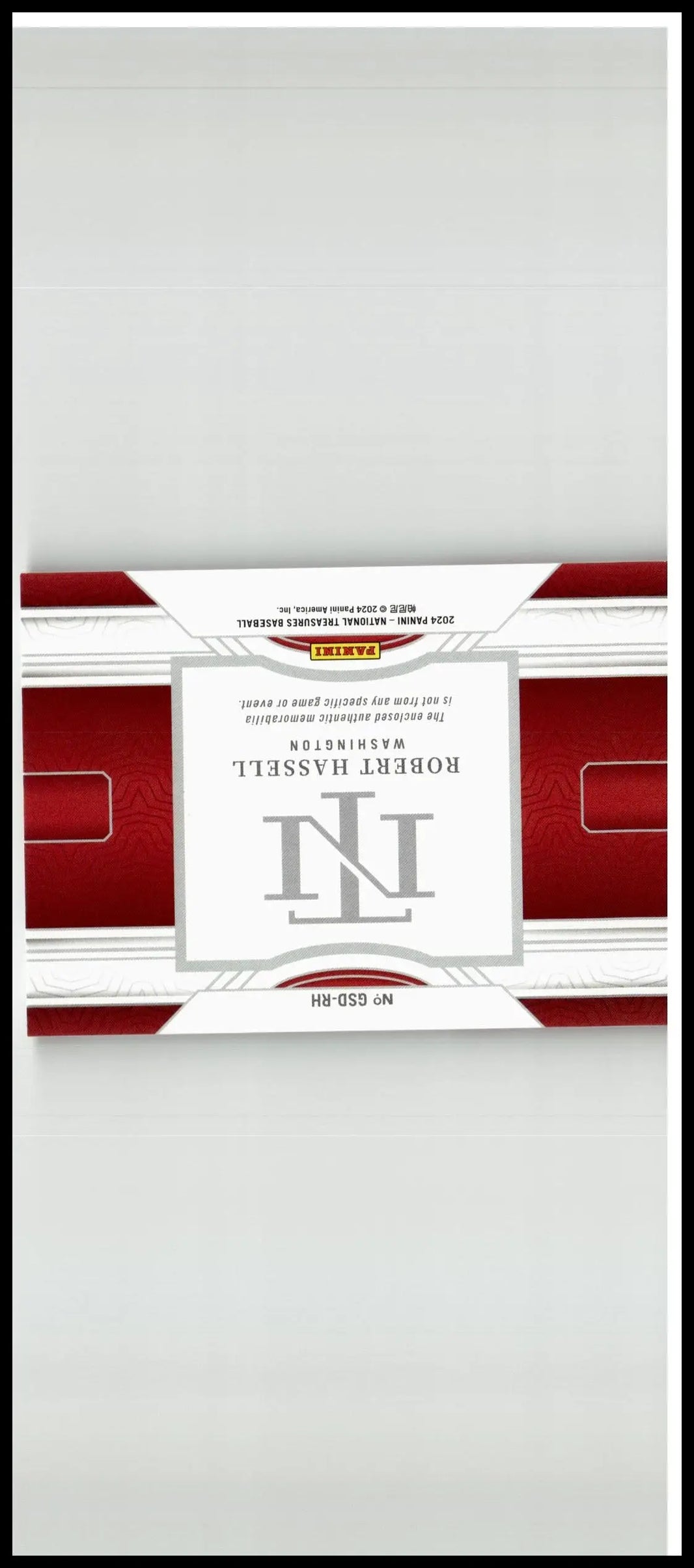 Red and white rectangular trading card pack with silver robert h logo from 2024 panini national treasures robert hassell game gear