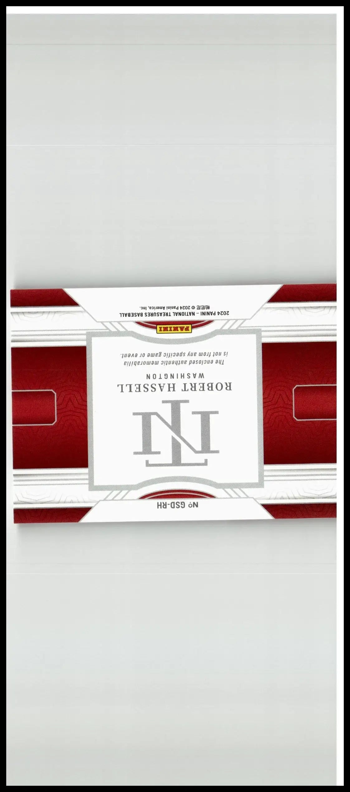 Red and white rectangular trading card pack with silver robert h logo from 2024 panini national treasures robert hassell game gear
