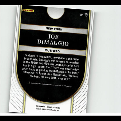 Black and gold baseball trading card featuring joe dimaggio, with white text on a glossy surface.