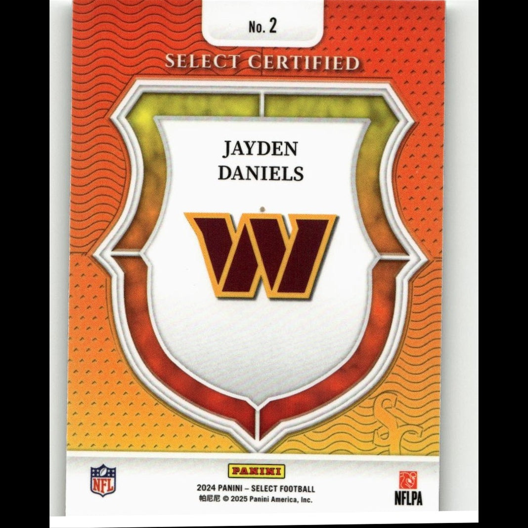 This is a 2024 panini select football trading card featuring jayden daniels with the washington commanders logo, designed in an orange and gold shield motif.