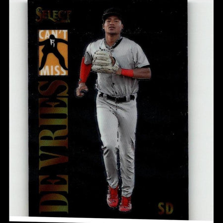 A baseball player in a gray uniform with red accents and matching red cleats, wearing a white glove.