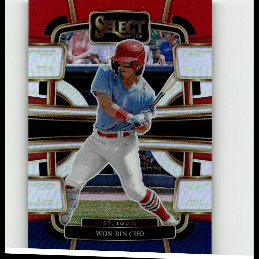 Red helmeted baseball player in a light blue jersey and white pants, captured mid-swing on a glossy trading card with gold trim.
