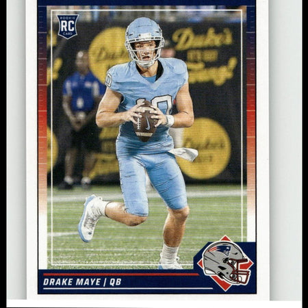 2023 score rookie card featuring drake maye in a light blue uniform and helmet, holding a football.