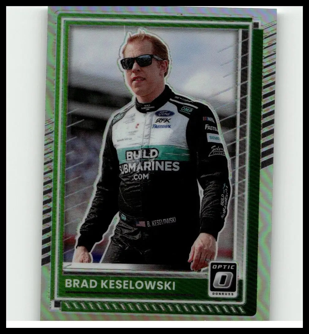 Green and black brad keselowski racing suit with sponsor logos featured in 2025 donruss brad keselowski optic holo card