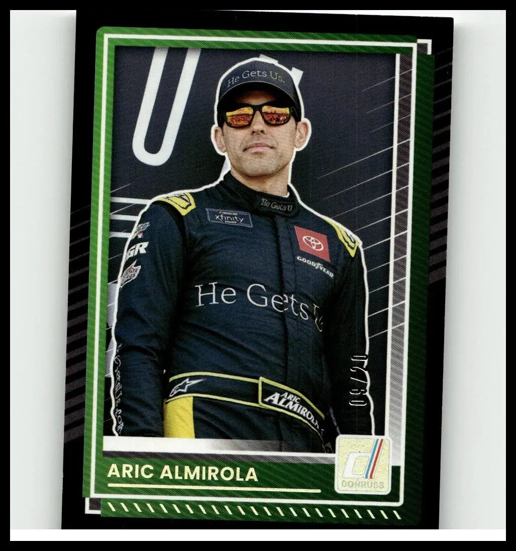Green and black framed 2025 donruss aric almirola numbers trading card featuring almirola in dark blue suit