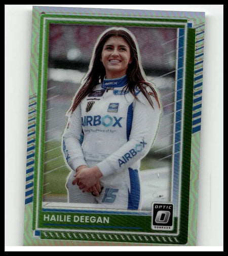 A green and blue holographic-bordered 2025 Donruss hailie deegan optic holo trading card featuring a smiling woman in a white airbox racing suit