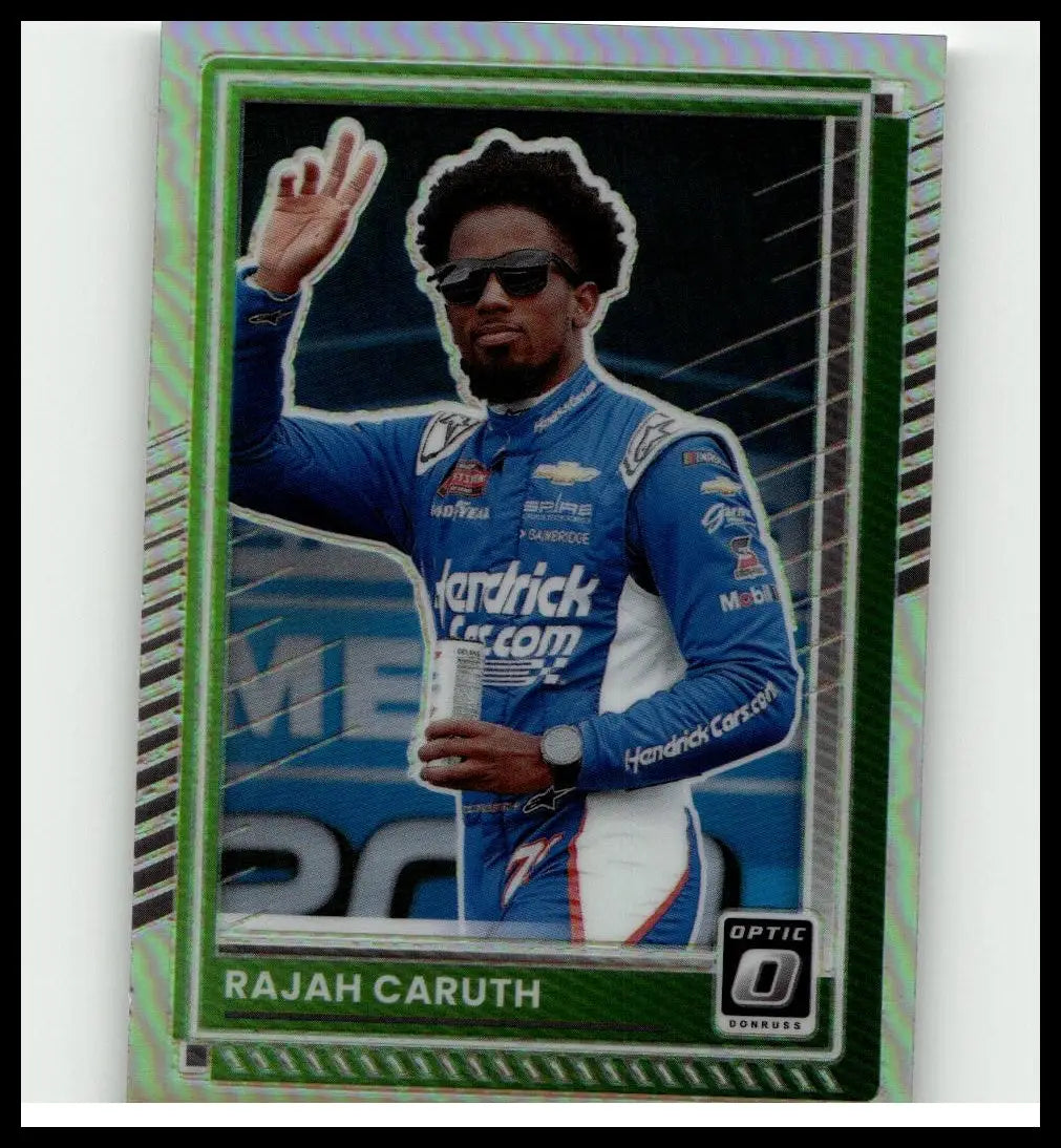 Green and silver bordered 2025 Donruss trading card featuring nascar driver Rajah Caruth in blue racing suit holding a can caruth optic holo