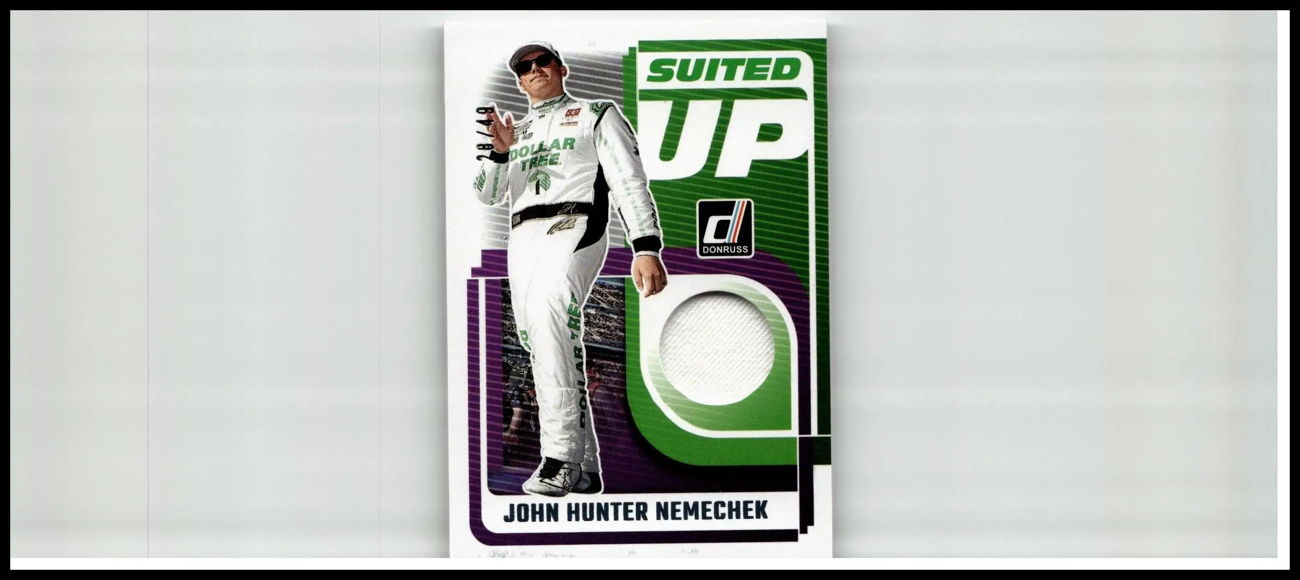 Green and purple suited up trading card featuring john hunter nemechek in white racing suit from 2025 donruss