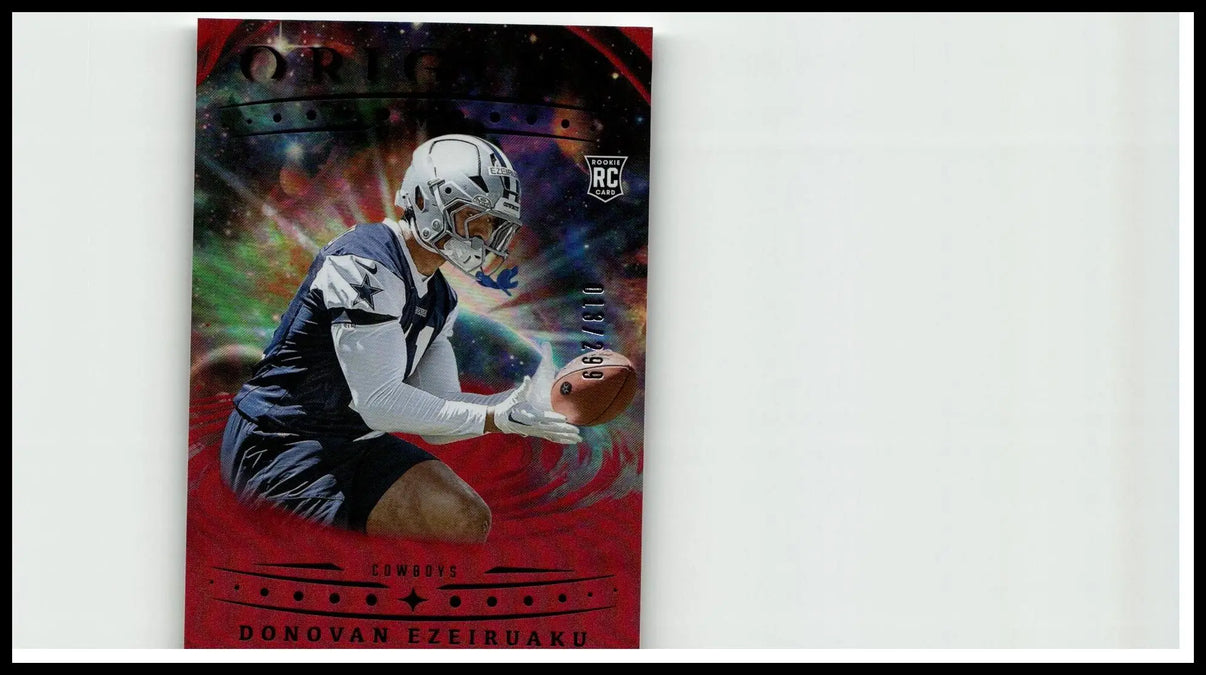 A vibrant red 2025 panini origins holo red football card featuring donovan ezeiruaku in dallas cowboys uniform