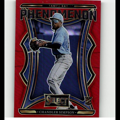 Red and blue tampa bay phenomenon baseball trading card featuring chandler simpson in a light blue jersey, gray pants, white cap with visor, black batting gloves, and gold-trimmed design elements.