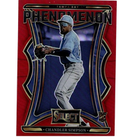 Red and blue tampa bay phenomenon baseball trading card featuring chandler simpson in a light blue jersey, gray pants, white cap with visor, black batting gloves, and gold-trimmed design elements.