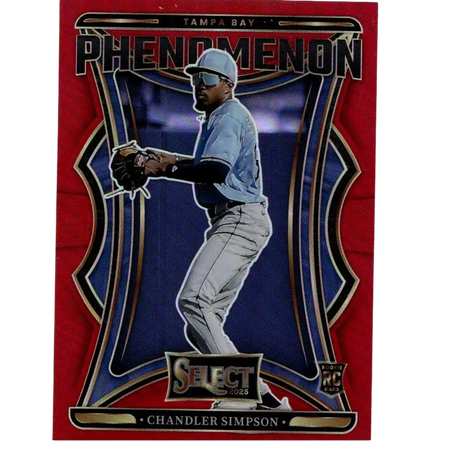 Red and blue tampa bay phenomenon baseball trading card featuring chandler simpson in a light blue jersey, gray pants, white cap with visor, black batting gloves, and gold-trimmed design elements.