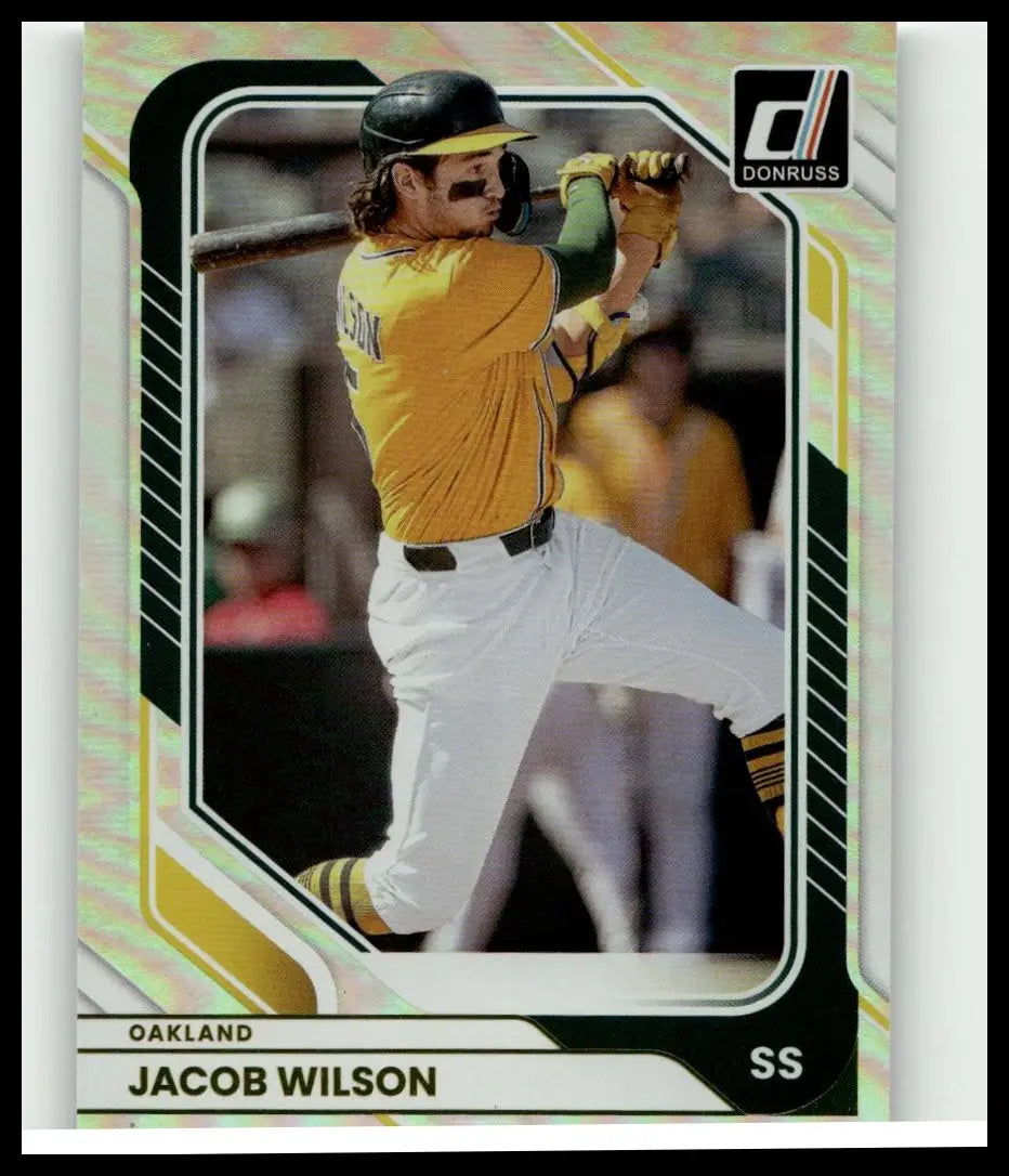2026 donruss #13 jacob wilson optic baseball trading card showing wilson in oakland athletics yellow jersey mid-swing