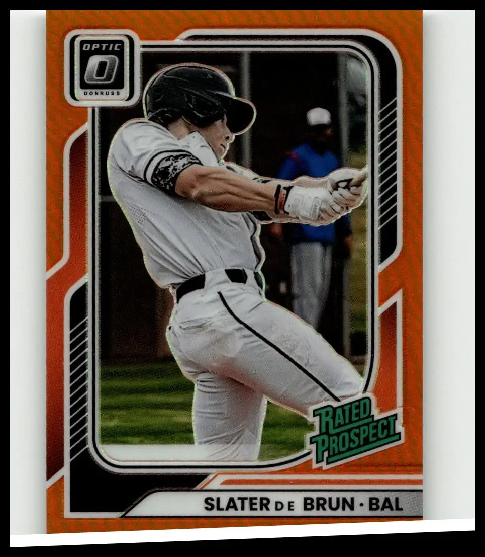 Orange-bordered 2026 Donruss Slater De Brun optic orange baseball card showing player mid-swing in white uniform