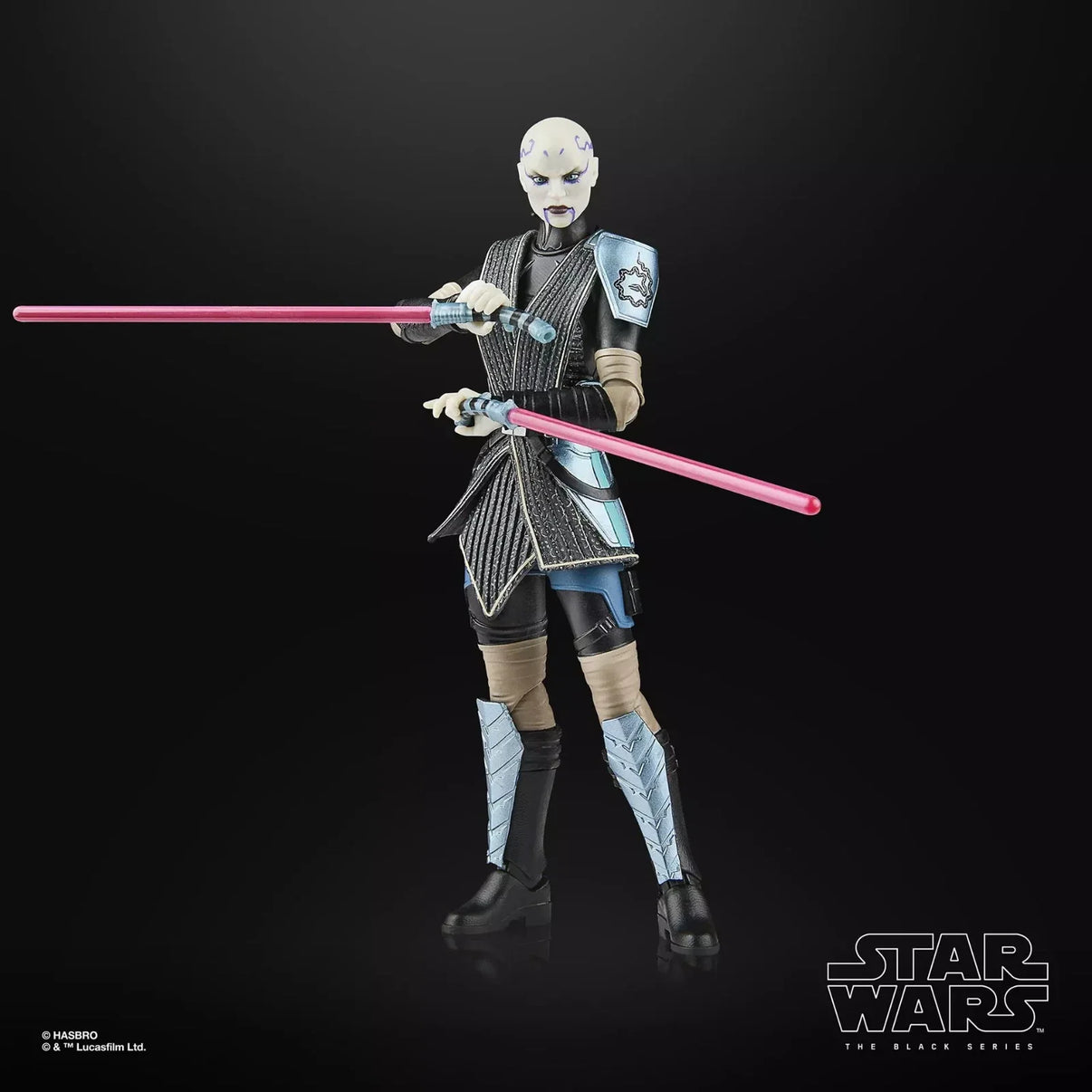 A star wars the black series action figure of asajj ventress, featuring a pale complexion with dark markings and wearing black, silver, and blue armor accented by tan straps, holding two pink lightsabers.