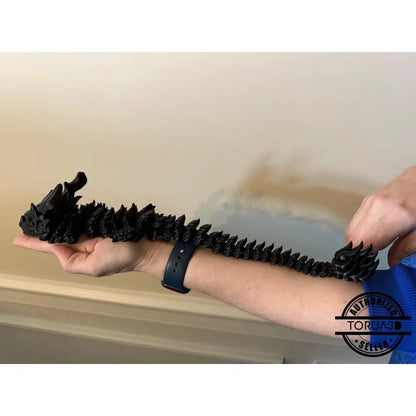 Articulated black dragon arm decoration.