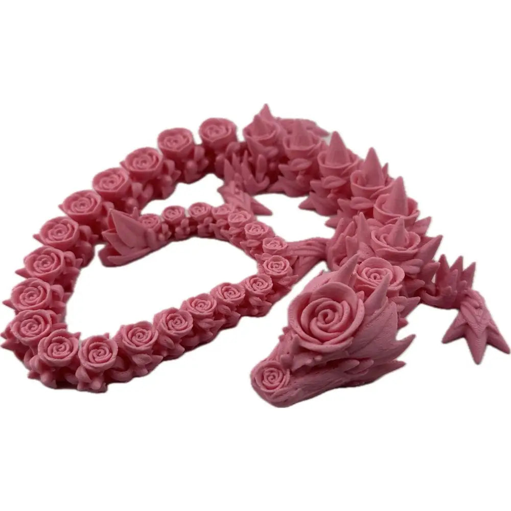 Pink rose-covered dragon figurine.