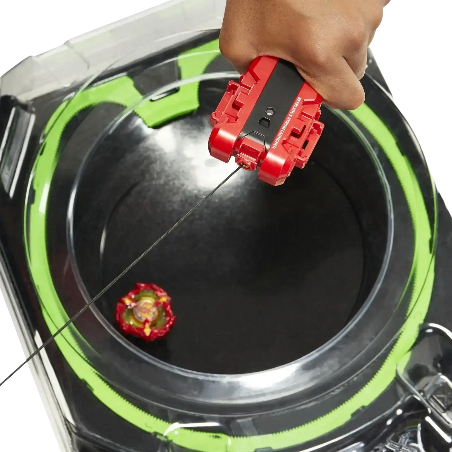 Red and black beyblade launcher with green accents being used to launch a red, yellow, and gold beyblade into the arena.
