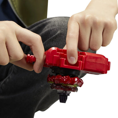 Red plastic beyblade launcher with a matching red and black spinning top attached.