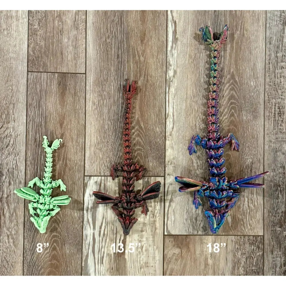 Three articulated dragon toys.