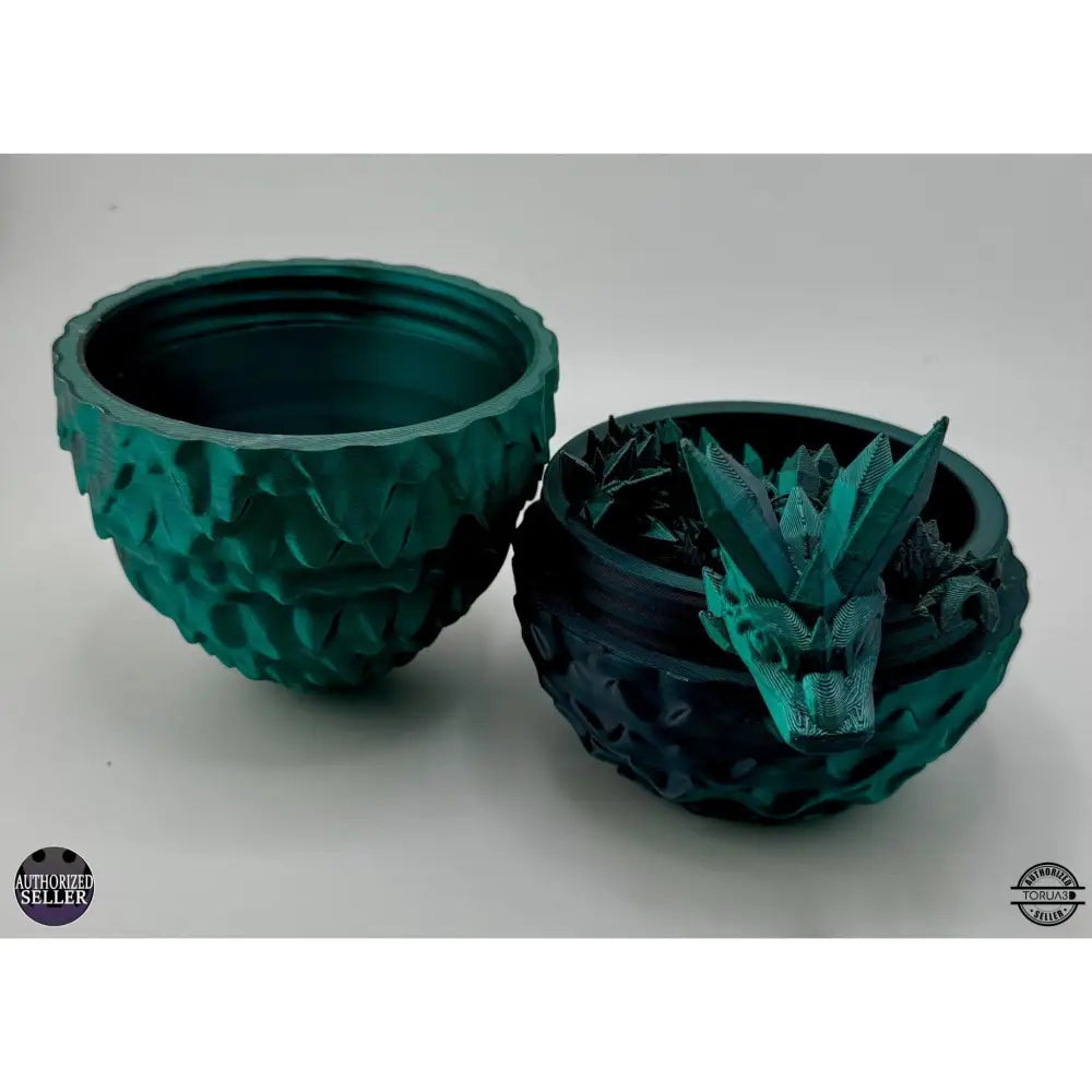Two green dragon egg planters.