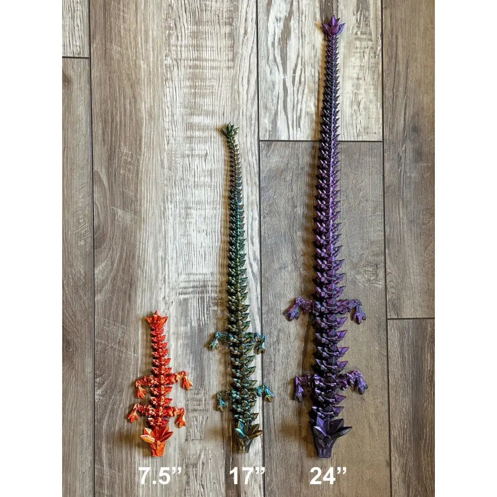 Three colorful articulated dragon figures.