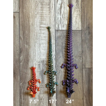Three colorful articulated dragon figures.