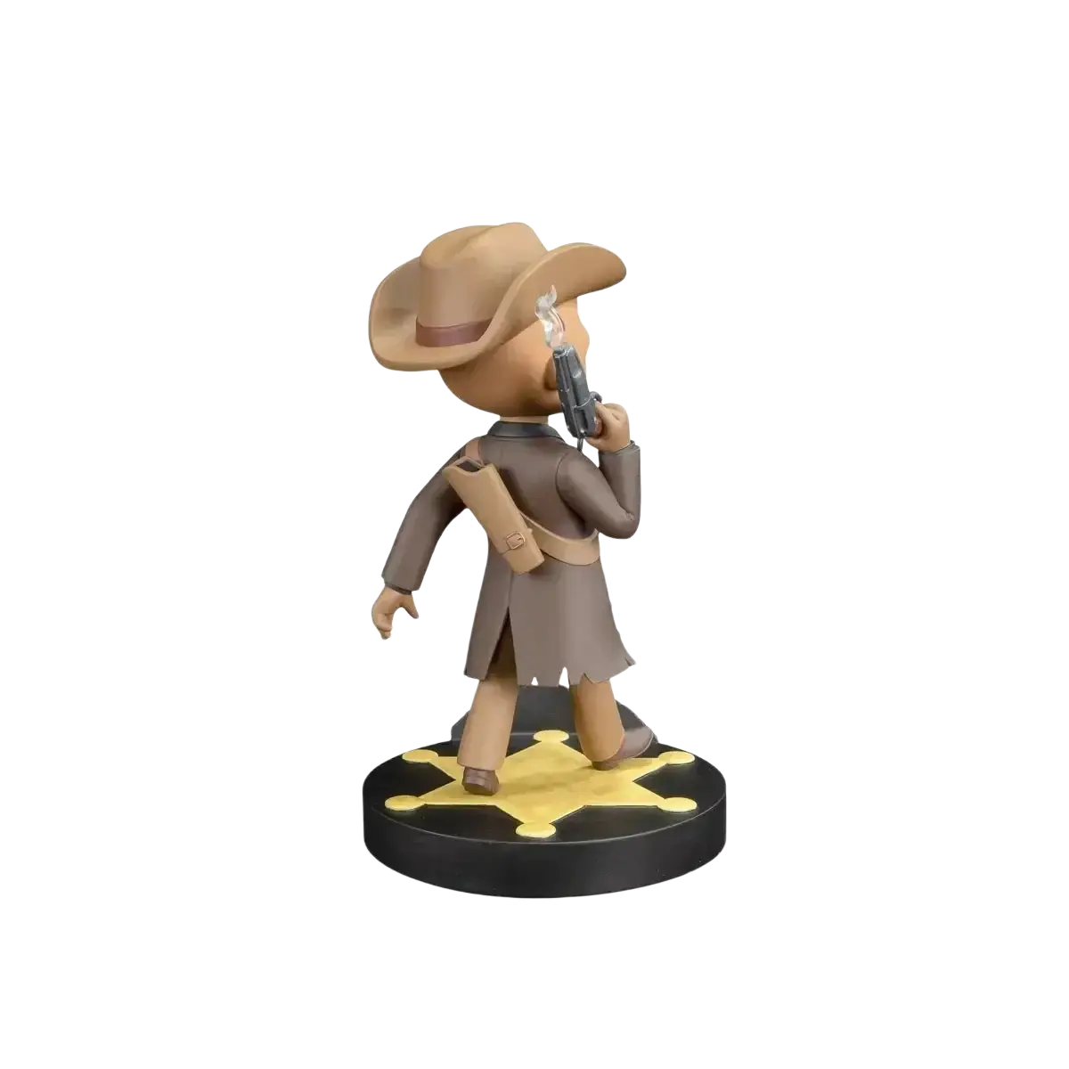 Tan cowboy figurine with a brown hat and coat, holding a silver revolver, standing on a black base with a gold star design.