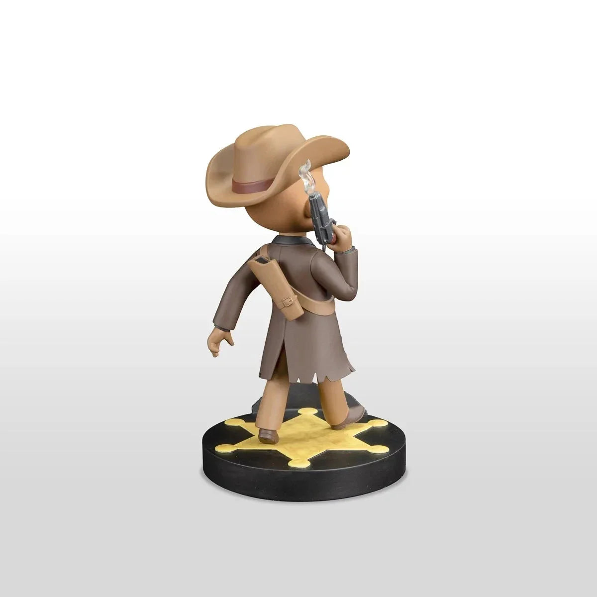 Tan cowboy figurine with a brown hat and coat, holding a silver revolver, standing on a black base with a gold star design.