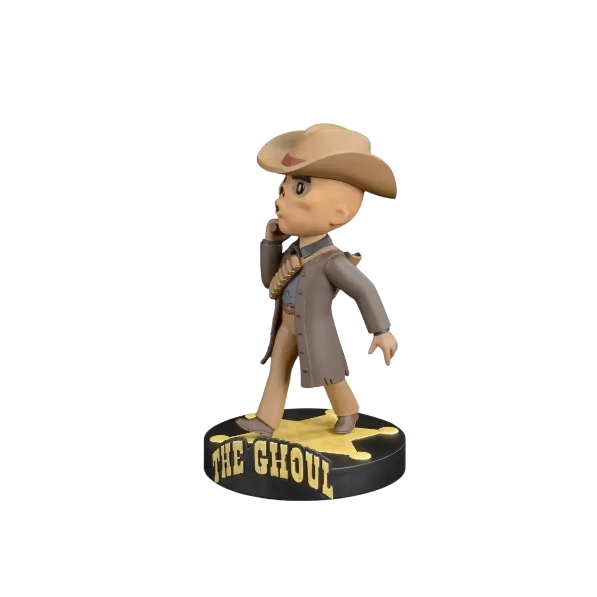 Tan cowboy-themed bobblehead figure wearing a brown hat and coat, standing on a black circular base with ’the ghoul’ in yellow lettering.