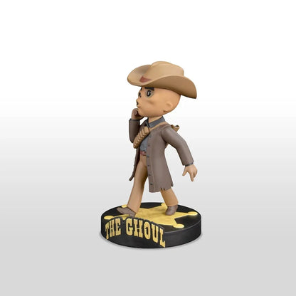 Tan cowboy-themed bobblehead figure wearing a brown hat and coat, standing on a black circular base with ’the ghoul’ in yellow lettering.