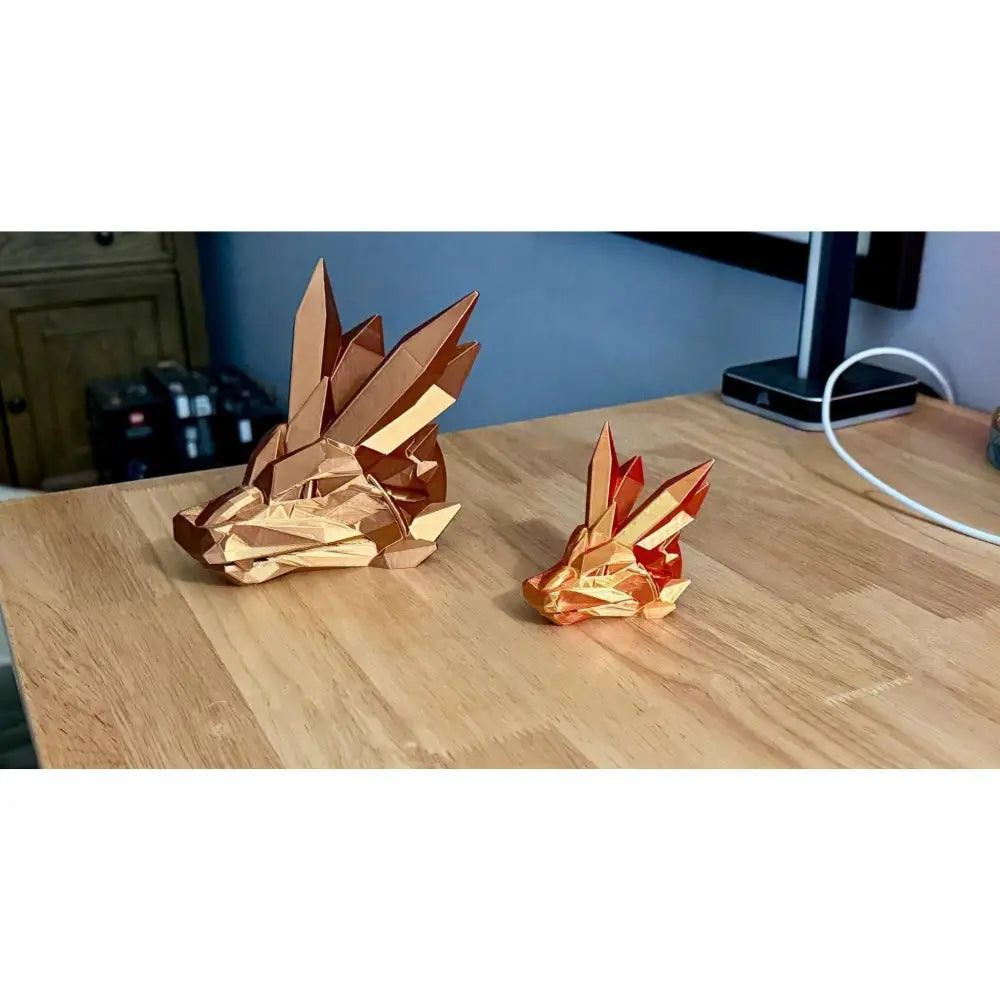 Two origami crystal fox heads.