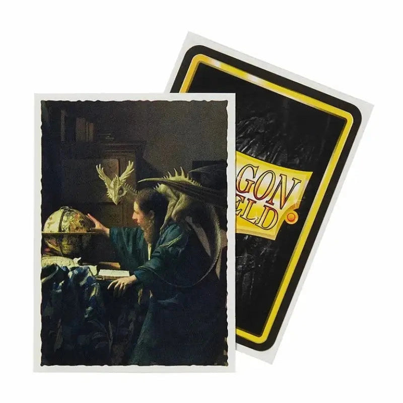 Two Dragon Shield card sleeves, one with an illustration of a person and a dragon, and the other with a black and yellow design.