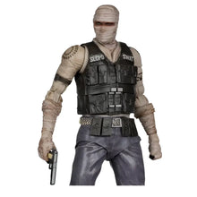 Joshua Graham action figure by McFarlane Gaming features a masked swat officer with beige bandages and black tactical gear