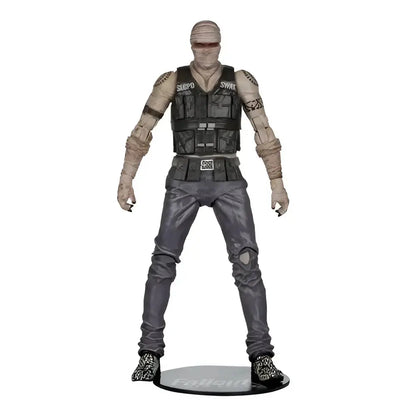 Gray and black joshua graham action figure with bandaged limbs wearing vest marked swe by mcfarlane gaming