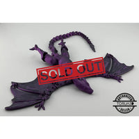 Purple articulated dragon figurine.