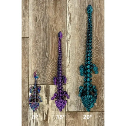 Three articulated dragon toys.