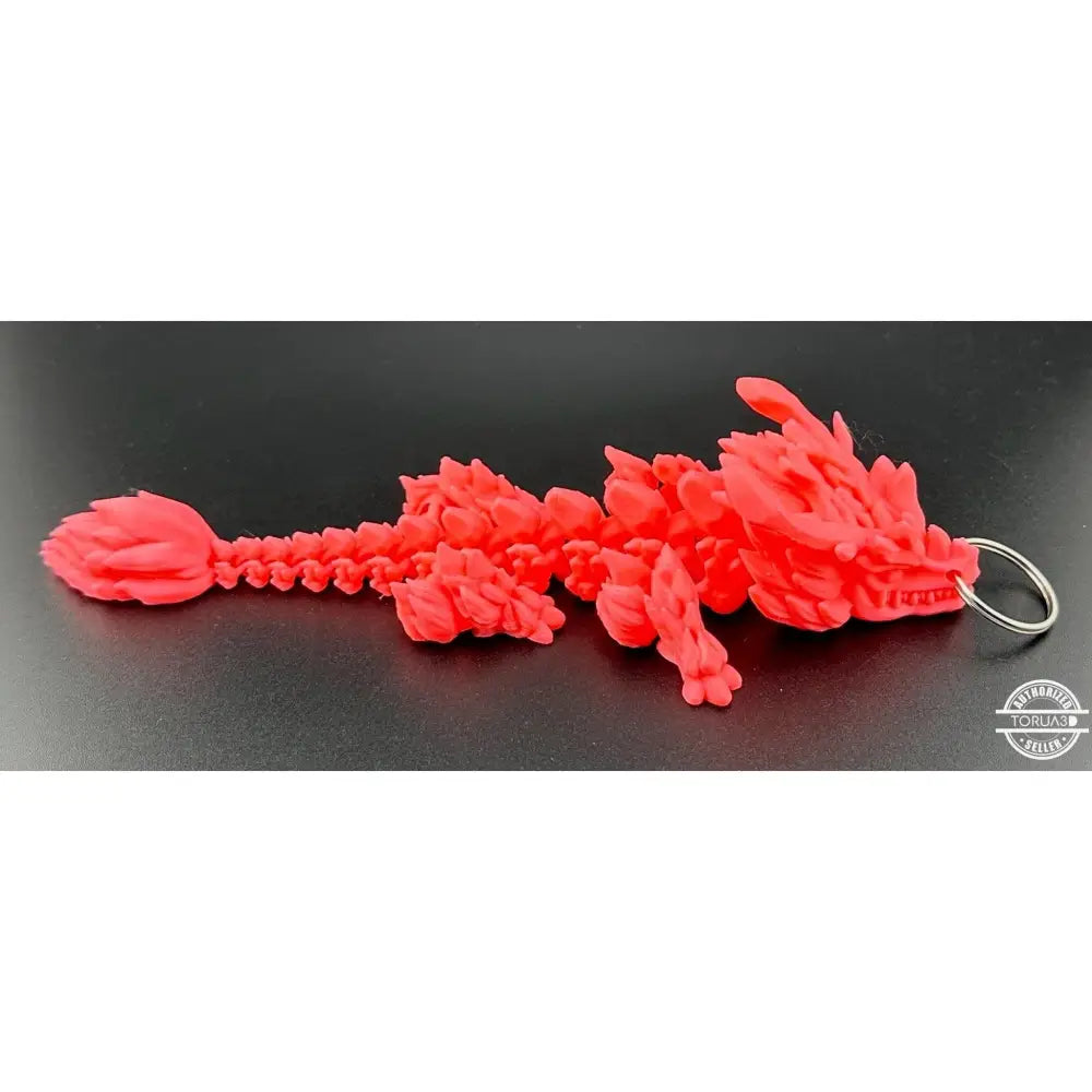 Red articulated dragon keychain.