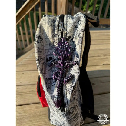 Cartoon-themed backpack with purple tassel.
