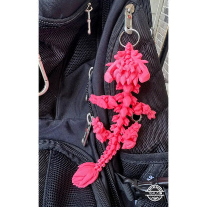 Pink 3D-printed dragon keychain.