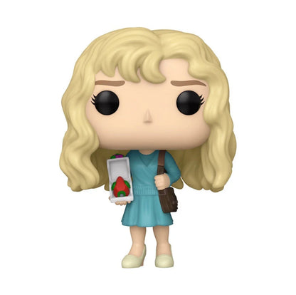 A blonde-haired funko pop! Figure dressed in a teal dress, holding an open box with a red strawberry inside and carrying a brown shoulder bag.