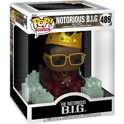 Funko pop deluxe action figure of notorious b.i.g. in red suit with gold crown and sunglasses seated on green throne