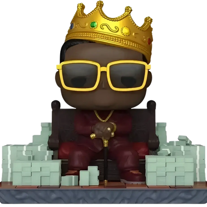 Funko pop action figure of the notorious big in red attire with a golden crown and yellow sunglasses holding a cane
