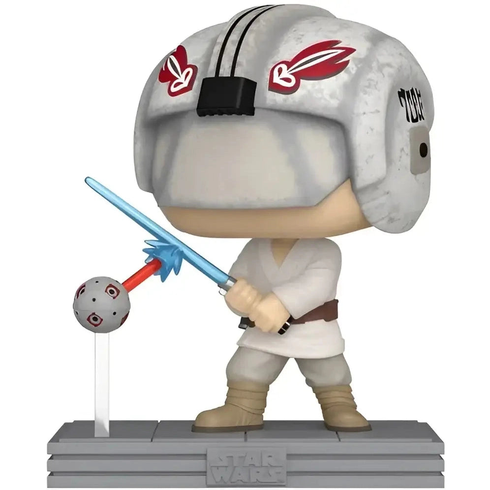 A Funko Pop! figure of Luke Skywalker in his training gear, deflecting a blast from a remote with a blue lightsaber.